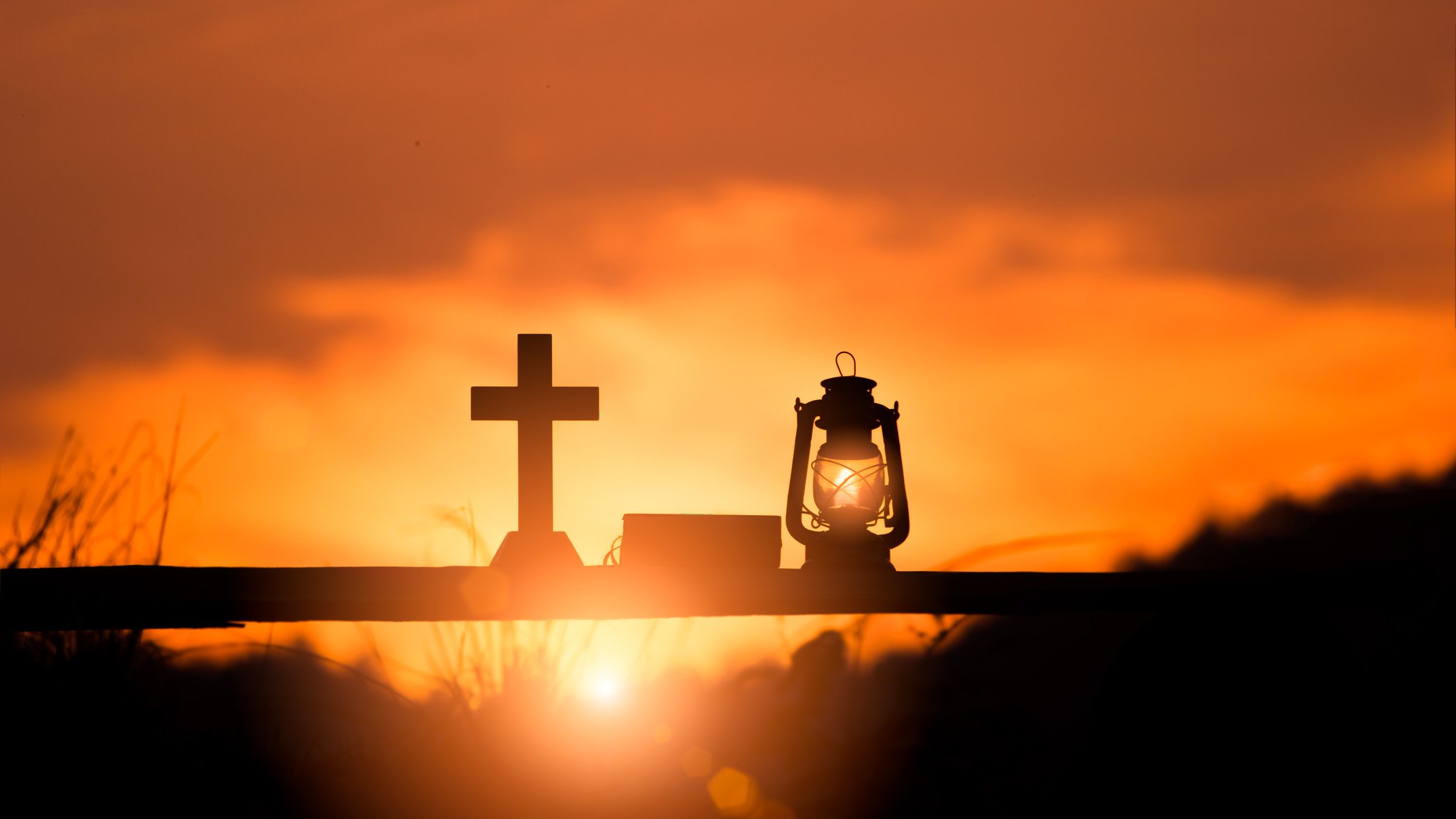 Silhouette of Crucifix and Bible